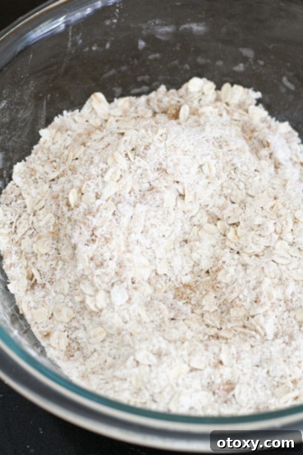 A glass bowl containing a perfect blend of flour and sugar, ready for the next step of the Anzac biscuit recipe.
