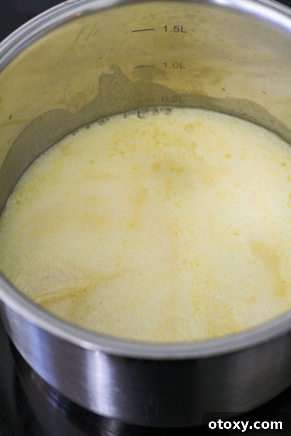 Melted butter gently simmering in a saucepan, the first step in creating the rich wet ingredients for Anzac biscuits.