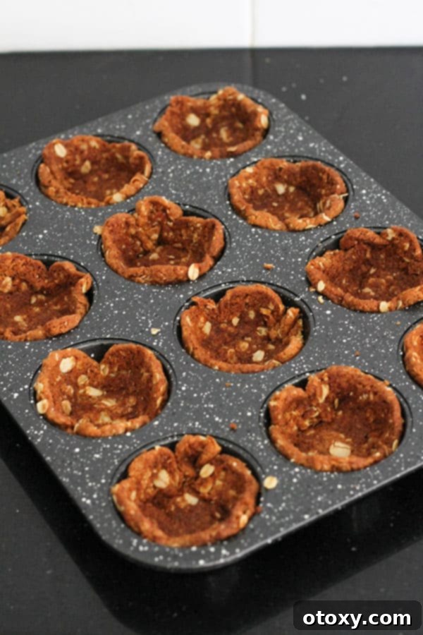 Luscious Caramel Tartlets 5 biscuits pushed into muffin tin holes to make tart cases.
