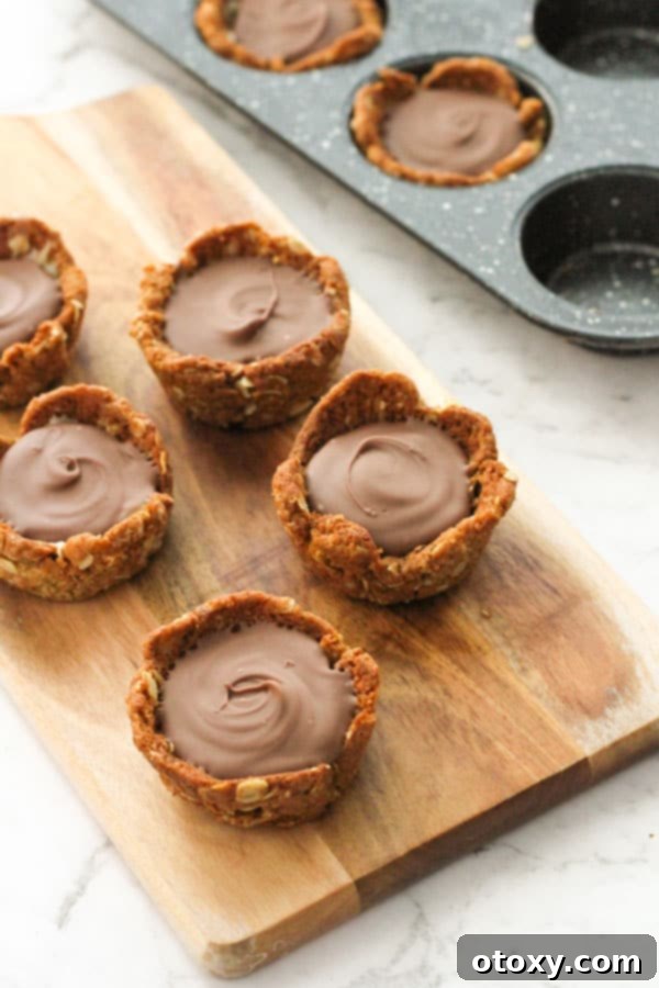 Luscious Caramel Tartlets 10 mini caramel tarts on a wooden board.