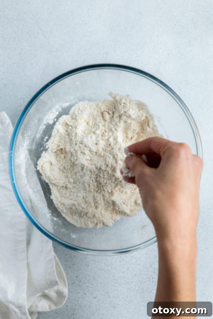 butter and flour being mixed together in a bowl.