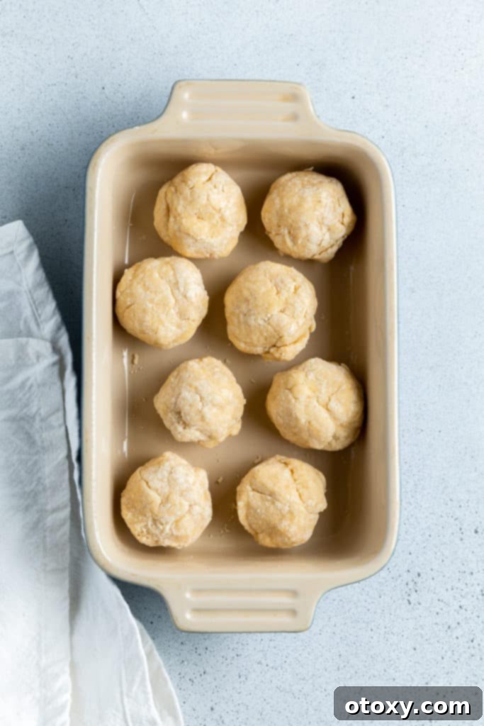 8 balls of dough in a baking dish.