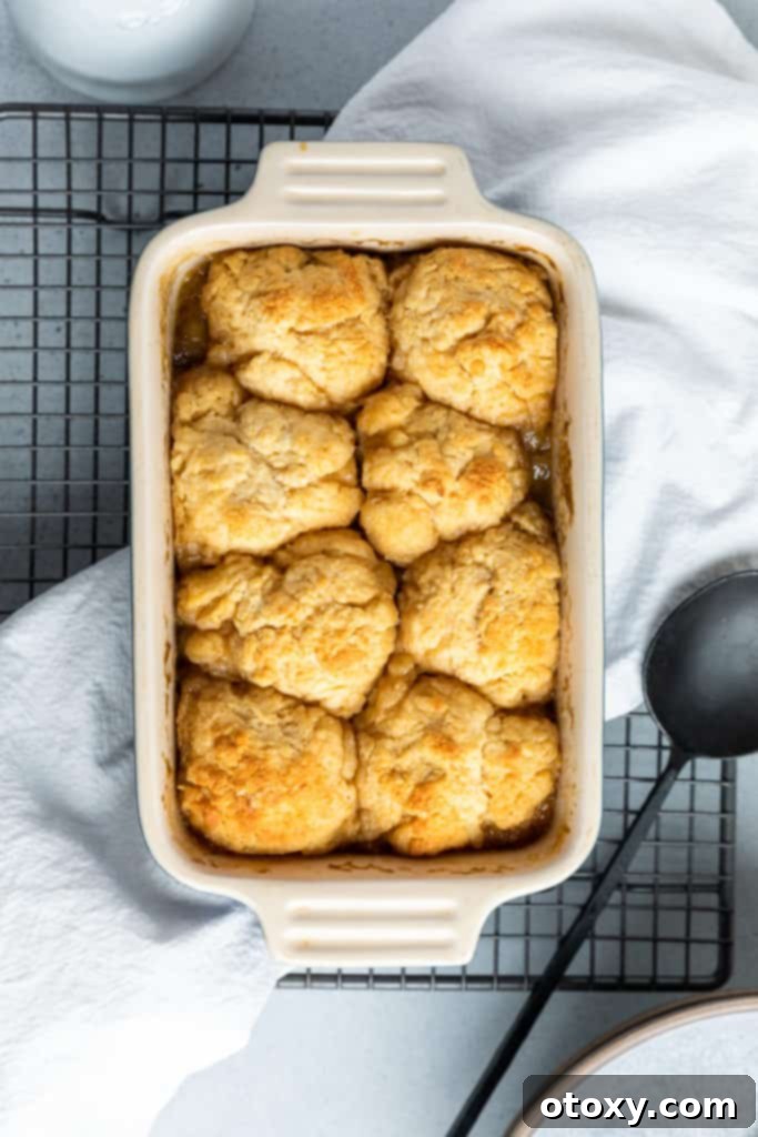 golden syrup dumplings in a baking dish on top of a wire tray.