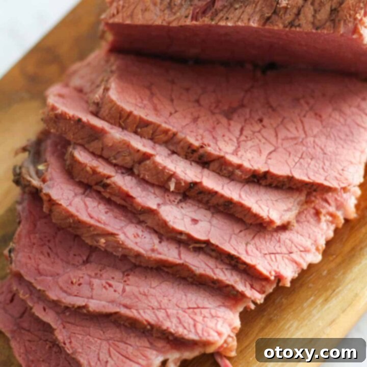 slices of corned beef on a wooden board.