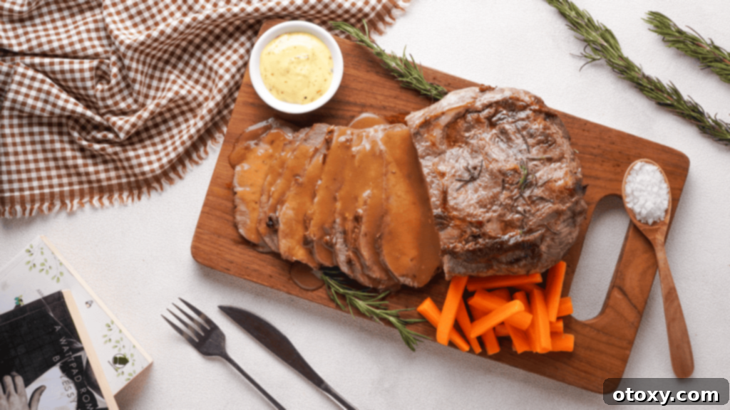 Perfect Air Fryer Roast Beef 3 Roast Beef with veggies, gravy and mustard on a wooden coaster made with air fryer.