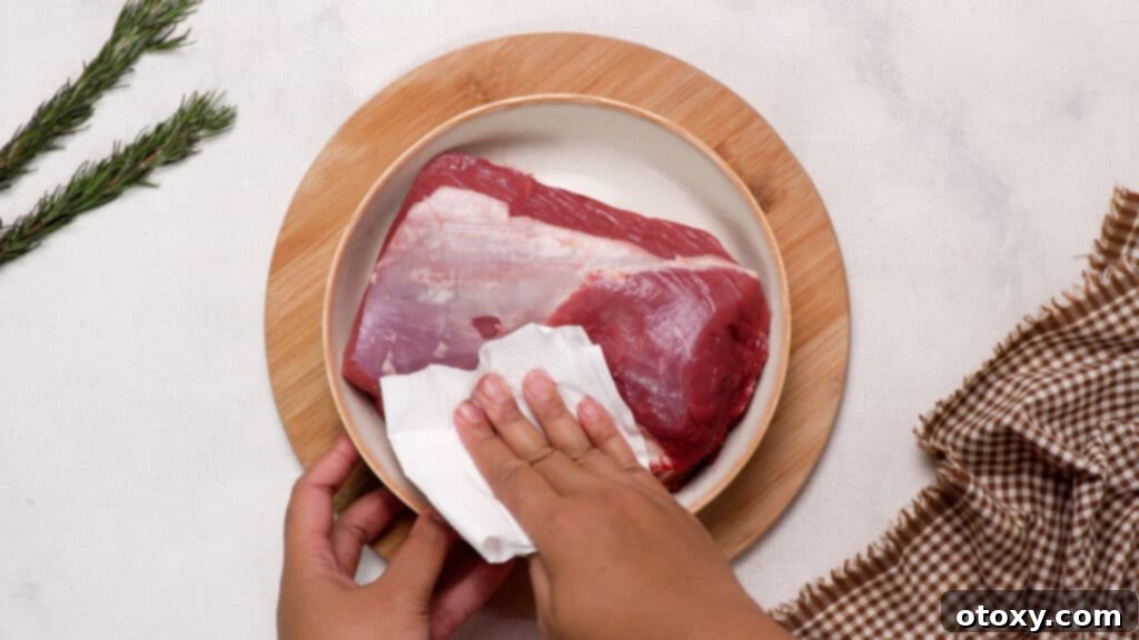 Perfect Air Fryer Roast Beef 8 Pat drying the beef with paper towels..