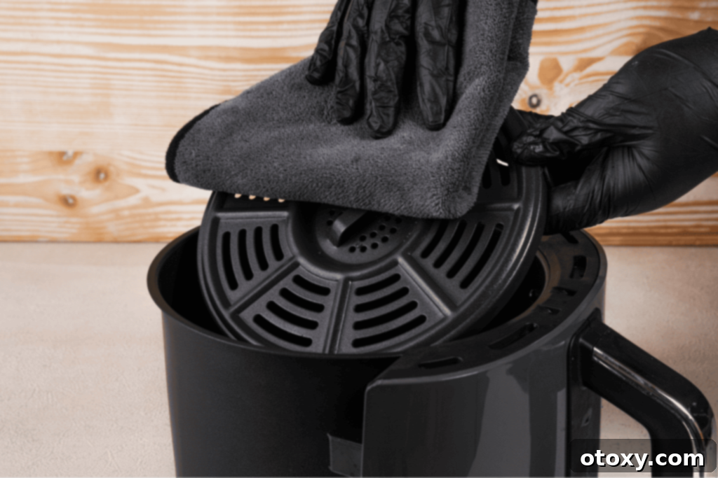 Cleaning air fryer tray with microfiber cloth