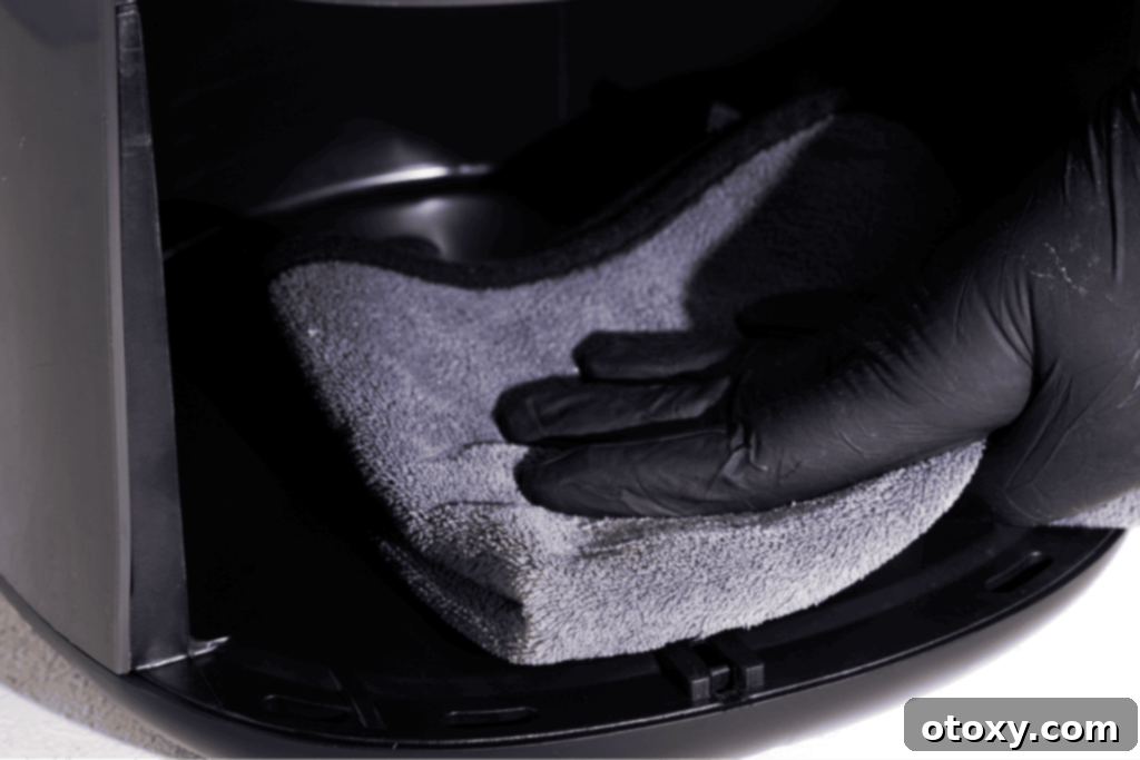 Cleaning air fryer interior with Microfiber cloth