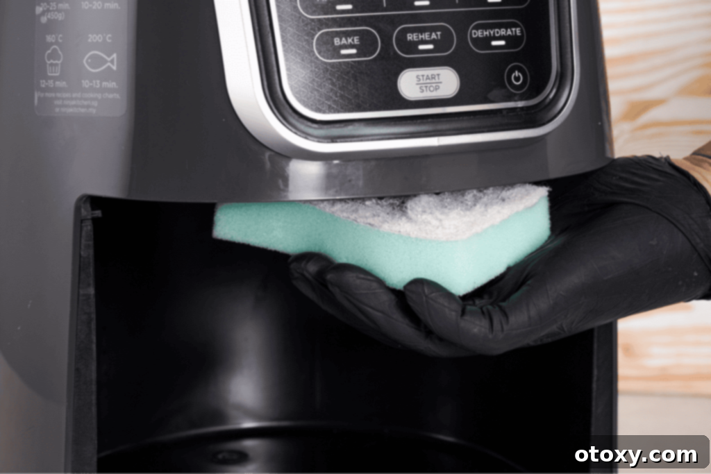 Cleaning the air fryer heating system with sponge