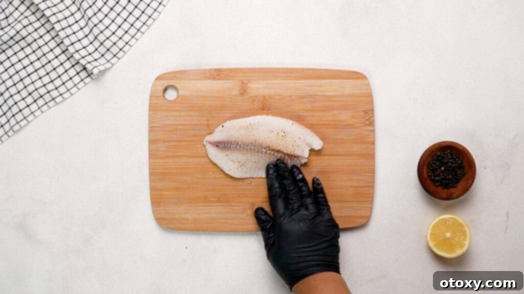 Crispy Air-Fried Tilapia with Zesty Garlic Butter 7 Tilapia fillet on cutting board
