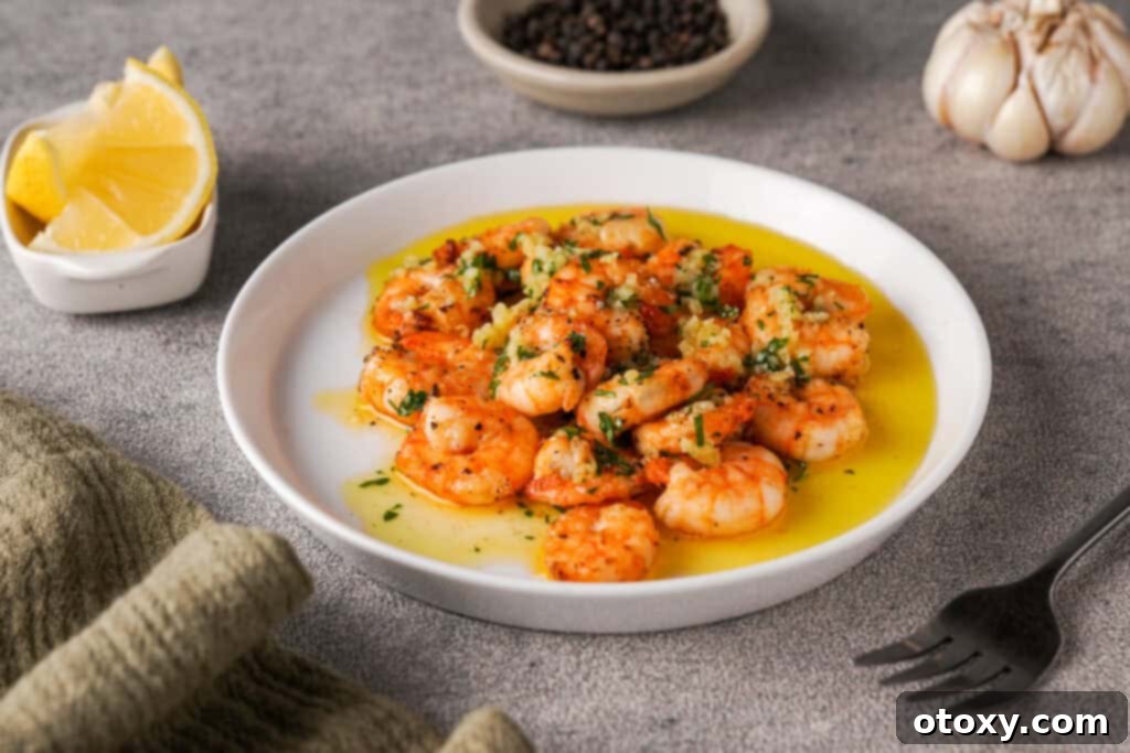 Air fryer shrimp on plate with lemon and parsley