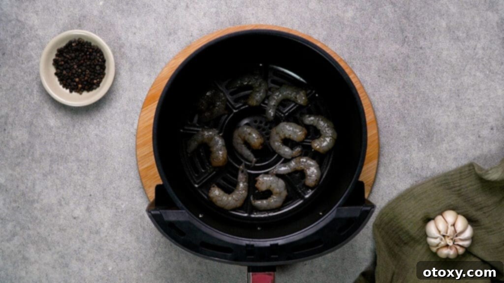 Shrimp arranged in a single layer in air fryer basket