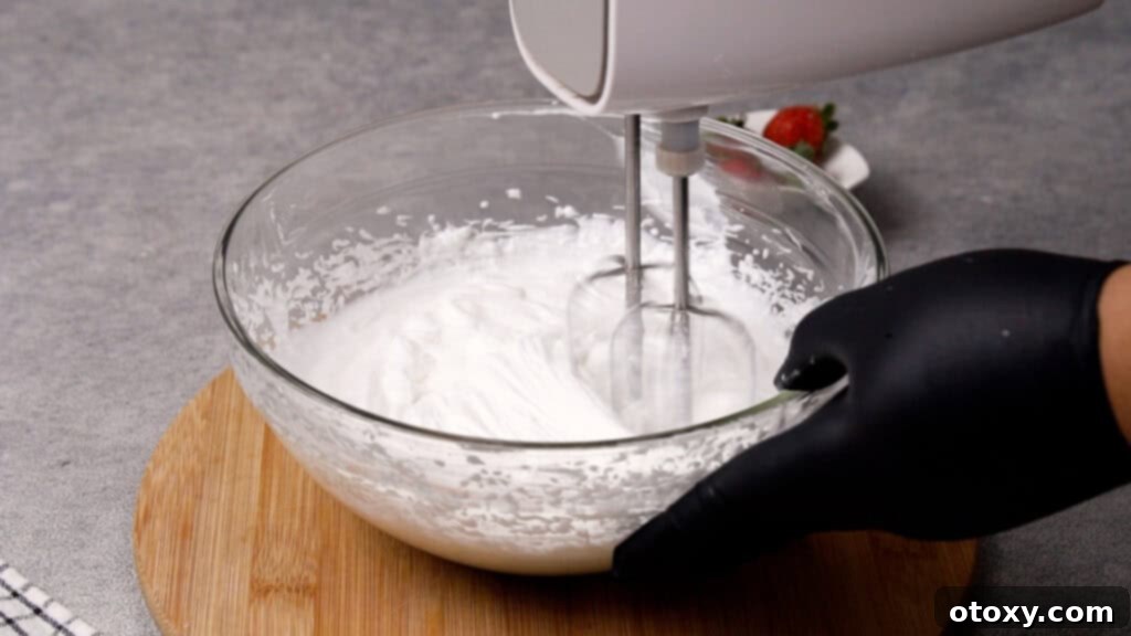 Step 2: Beating the Cool Whip and juices until smooth and fluffy.