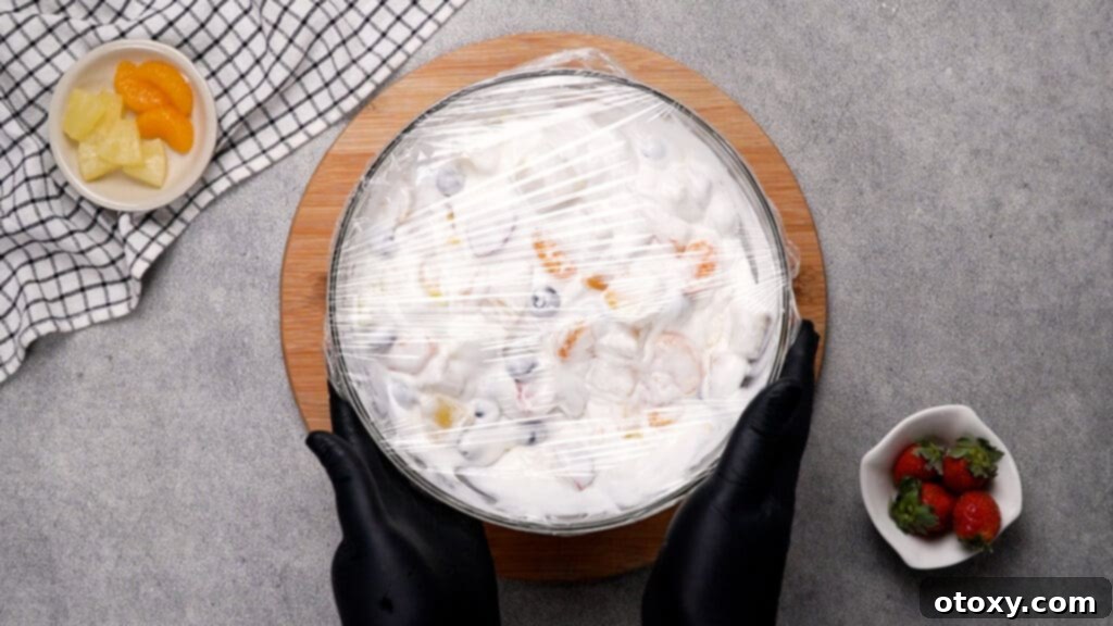 Step 5: Covered fruit salad chilling in the refrigerator.