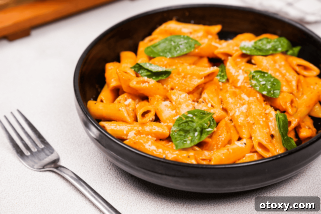 A beautifully plated Gigi Hadid Pasta with an added protein (chicken or shrimp) or roasted vegetables, garnished with basil, illustrating variations.