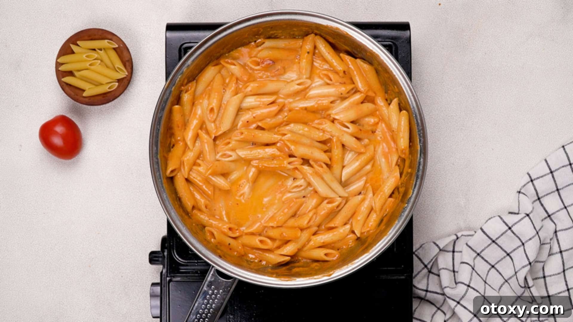 Pasta being tossed in sauce.