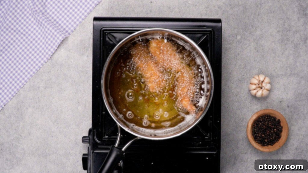 Chicken tempura frying in hot oil