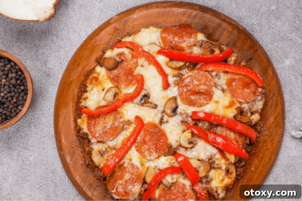 A perfectly baked, golden-brown crustless pizza brimming with melted cheese, vibrant pepperoni, and fresh vegetables, ready to be sliced and served.