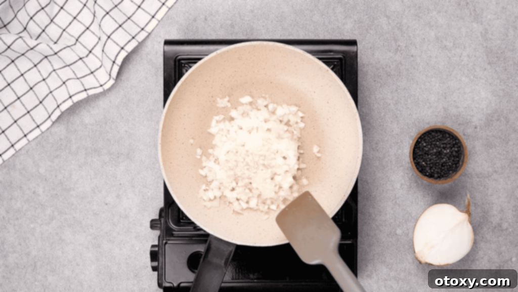 Chopped onions and minced garlic sizzling in olive oil in a non-stick skillet over medium heat.