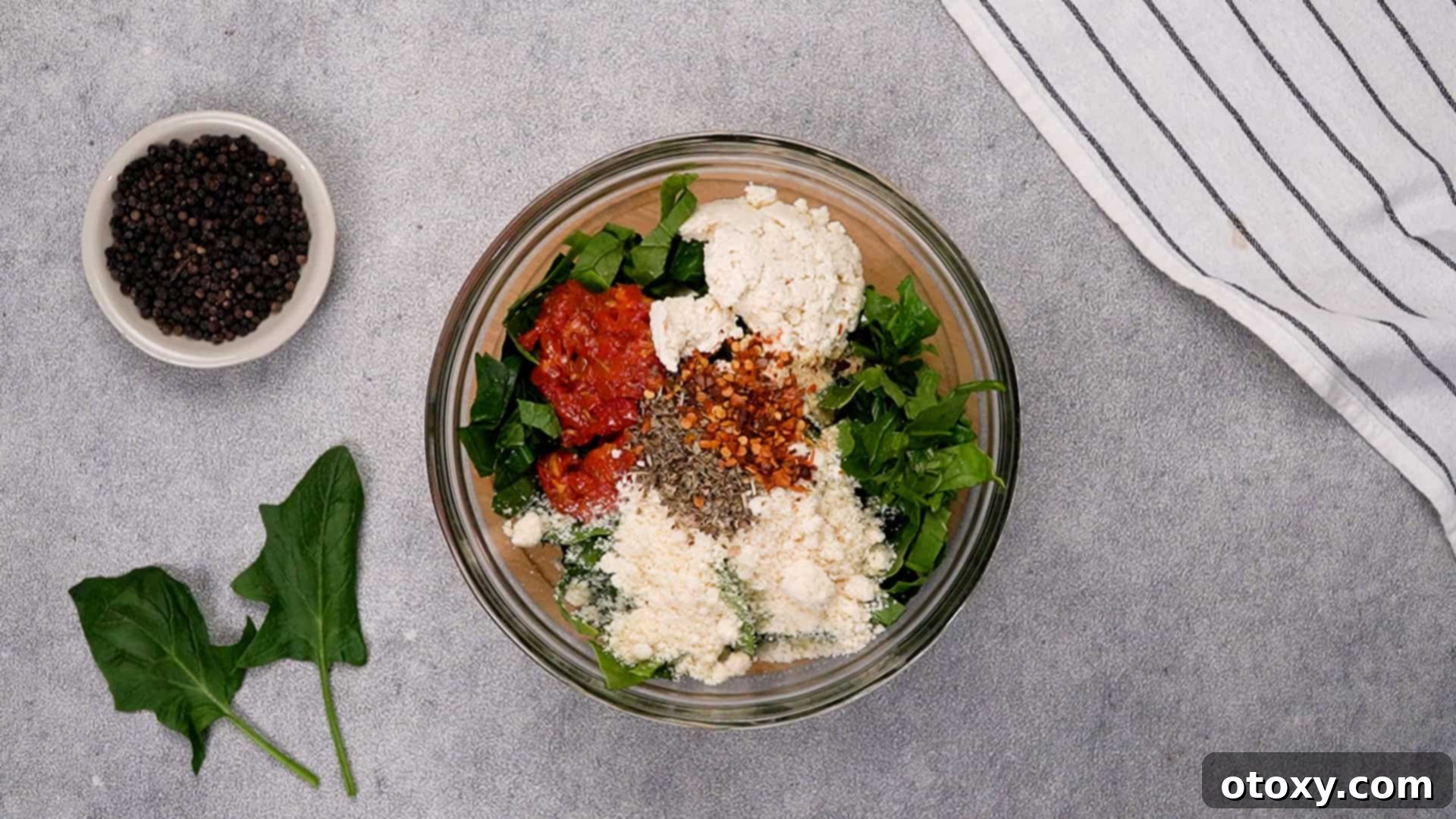 Mixing ingredients for the creamy spinach and cheese filling.