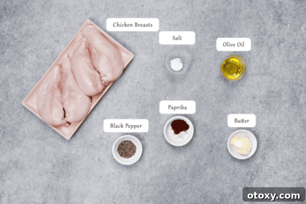 Fresh chicken breasts seasoned with spices and olive oil, ready for preparation.