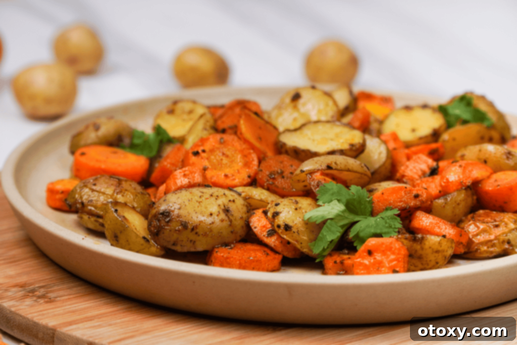 Herb Roasted Potatoes and Carrots 2 Close-up of perfectly roasted potatoes and carrots on a serving plate