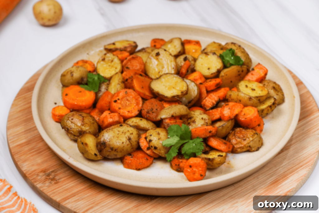 Herb Roasted Potatoes and Carrots 12 Roasted potatoes and carrots on a platter with herbs