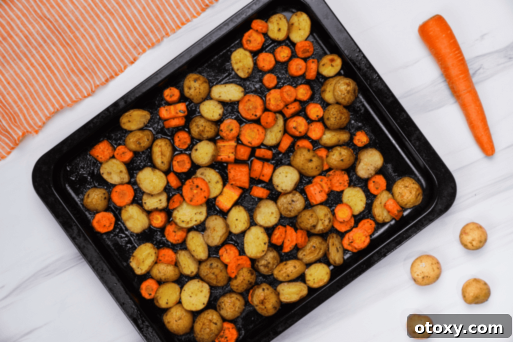 Herb Roasted Potatoes and Carrots 13 A bowl of roasted potatoes and carrots with fresh herbs