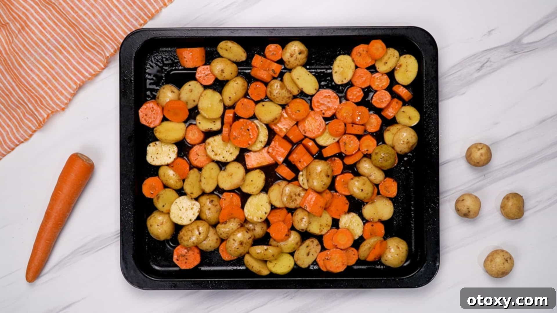 Herb Roasted Potatoes and Carrots 19 Potatoes and carrots spread on a baking sheet