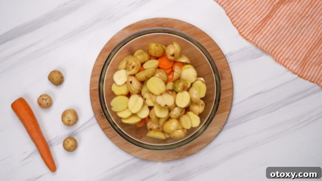 Herb Roasted Potatoes and Carrots 6 Large bowl filled with potatoes and carrots, ready for seasoning