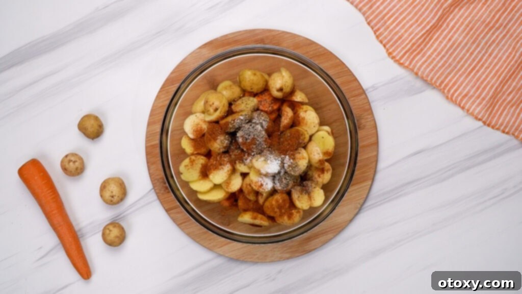 Herb Roasted Potatoes and Carrots 7 Potatoes and carrots in a bowl, drizzled with olive oil, butter, and honey, seasoned with spices