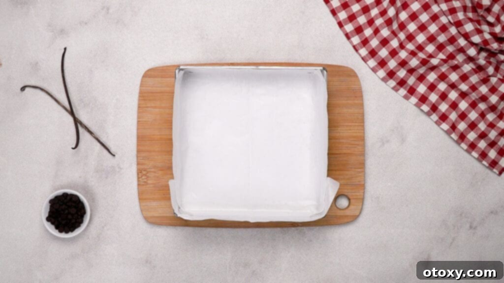 Square baking pan lined with parchment paper