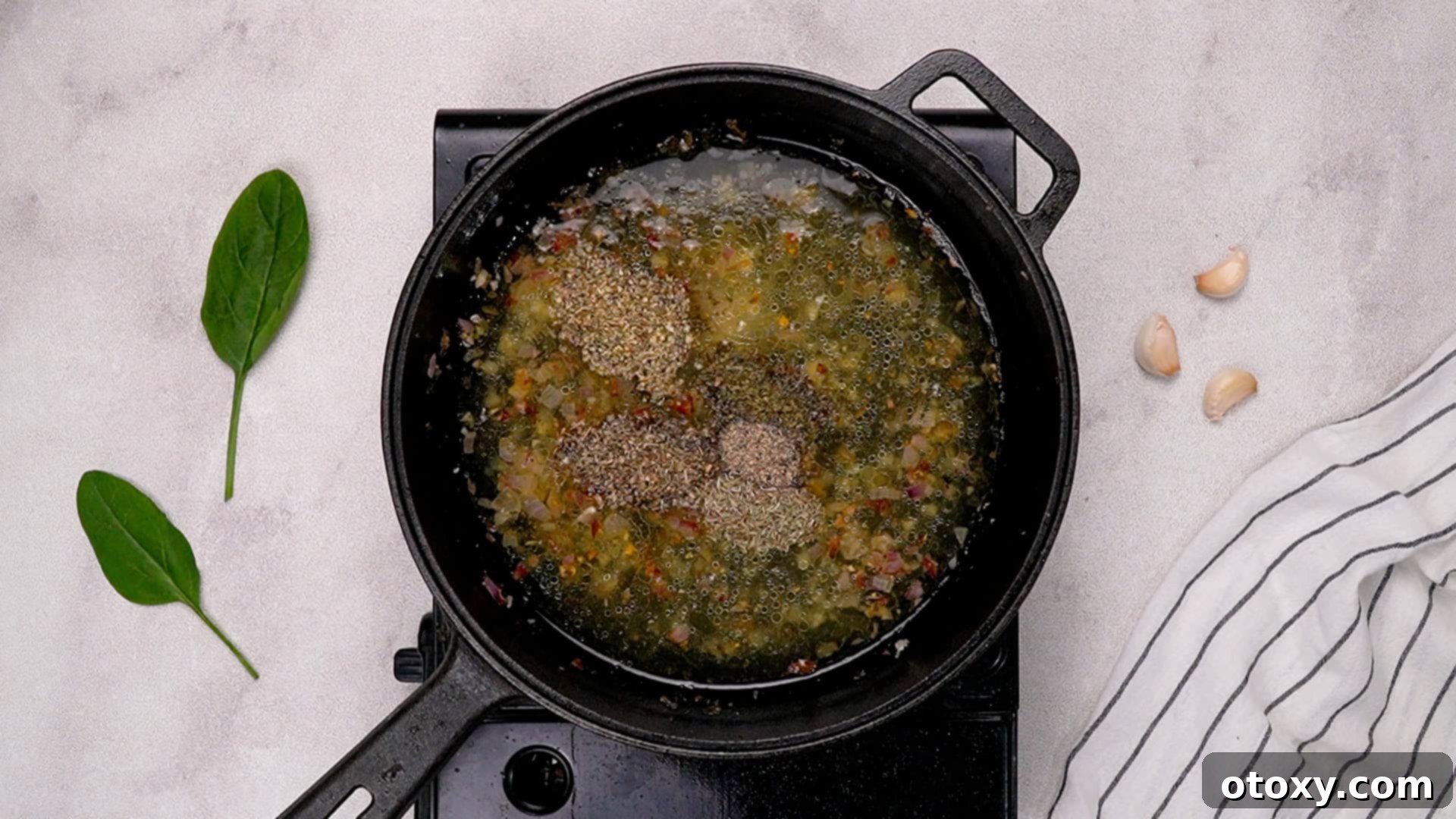 Sautéing shallots and garlic, then adding broth and herbs