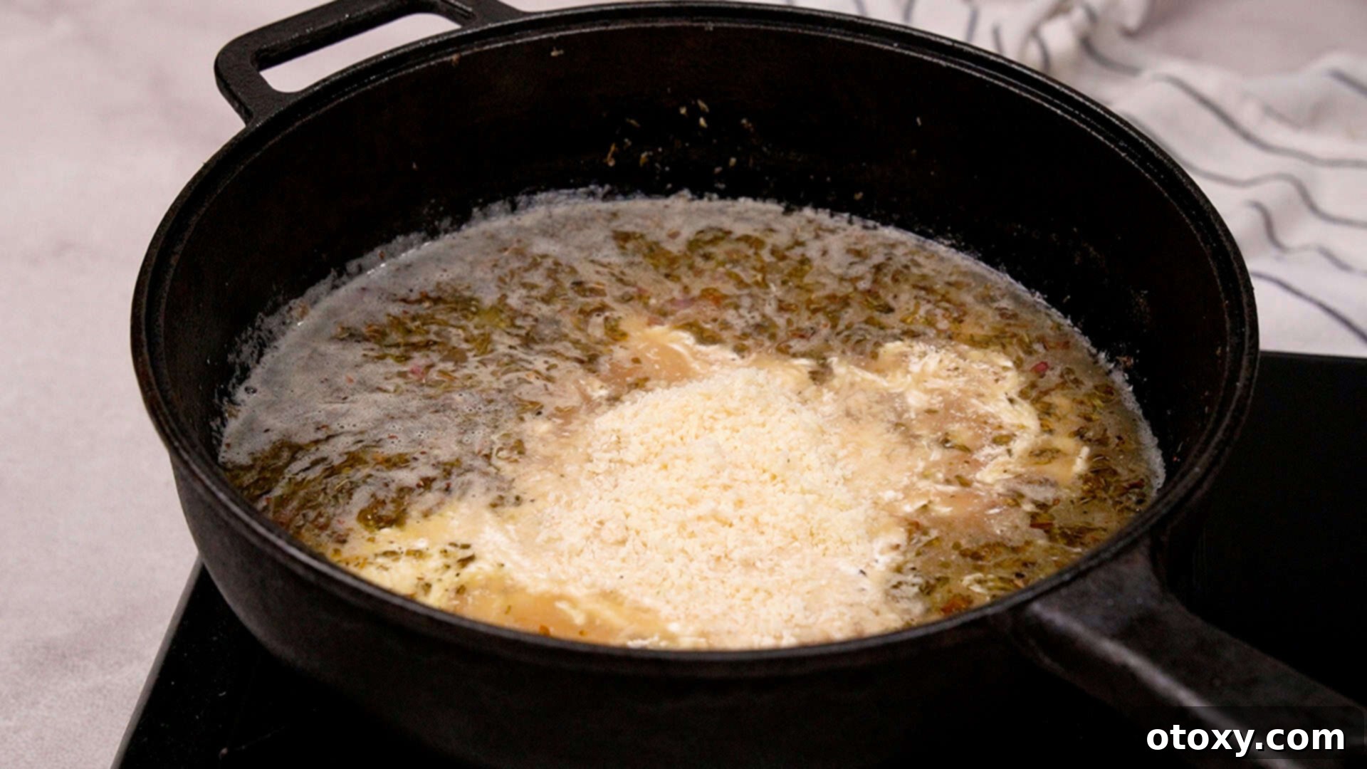 Stirring heavy cream and Parmesan into the sauce