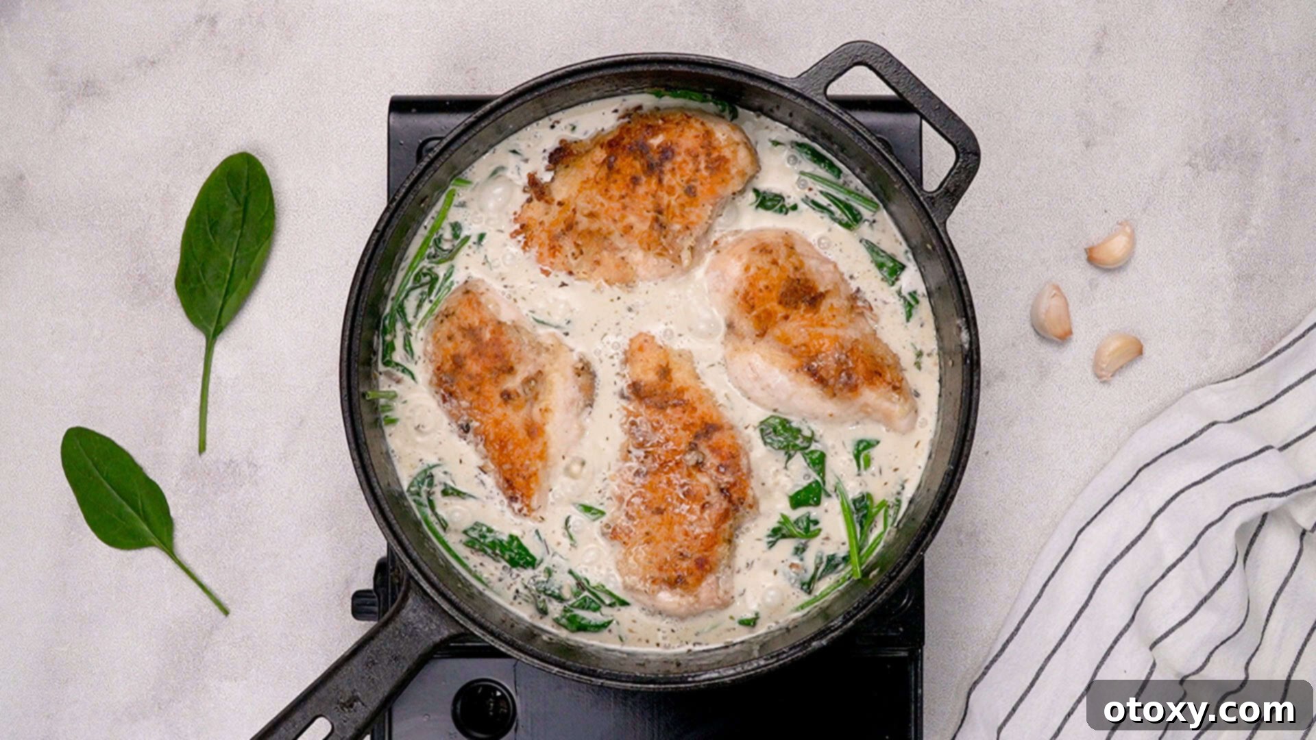 Chicken returning to the skillet to finish cooking in the sauce