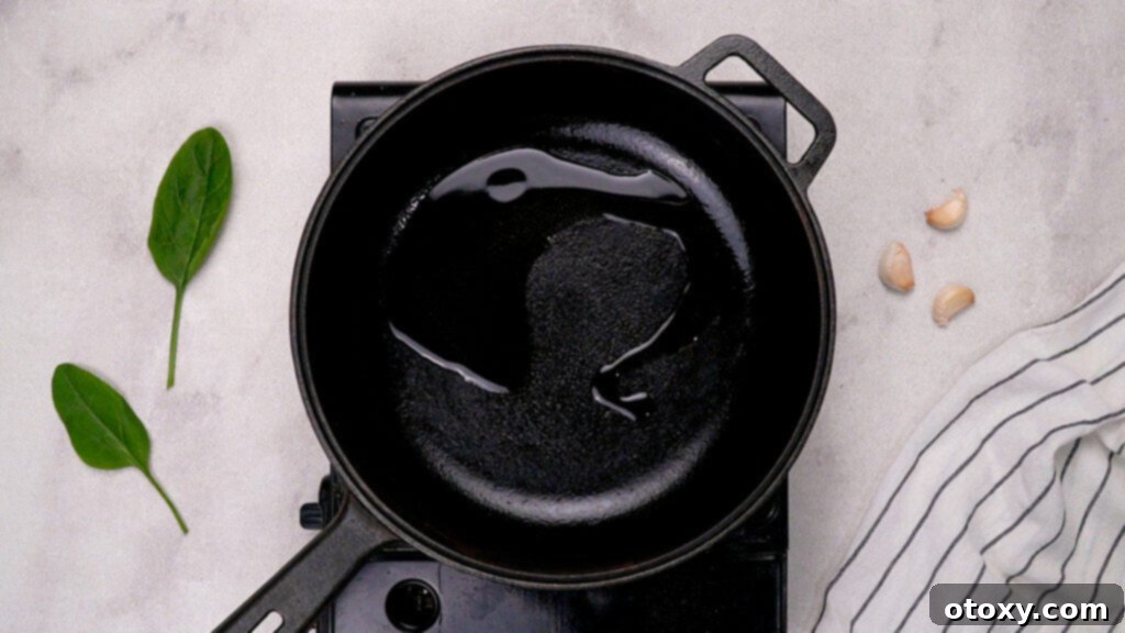 Olive oil heating in a large skillet over medium-high heat