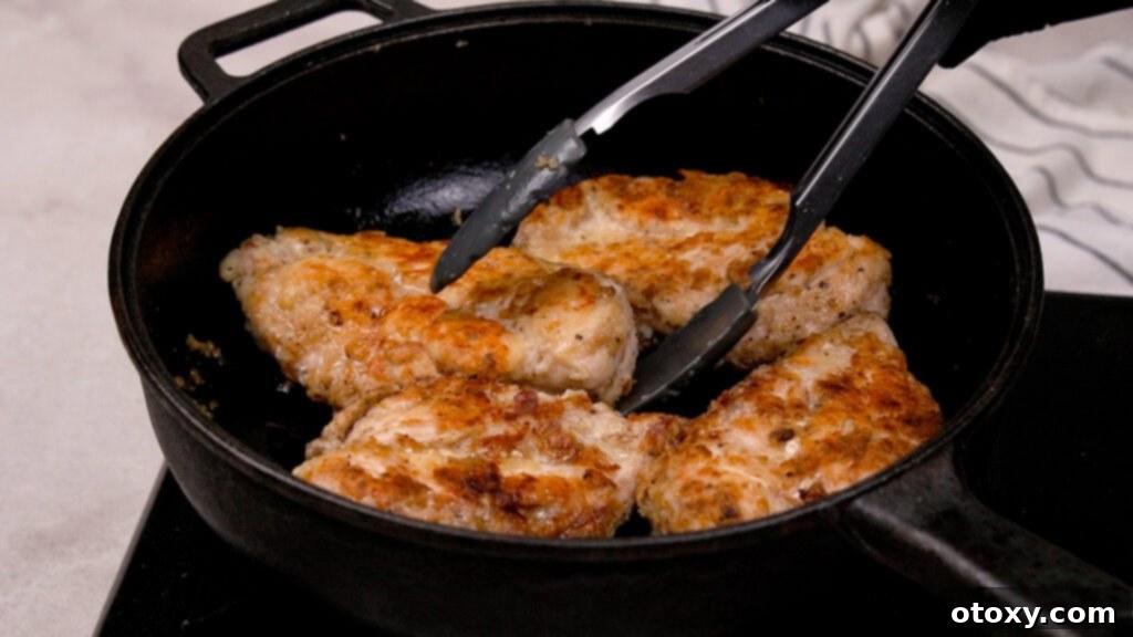 Golden-brown seared chicken cutlets resting on a plate