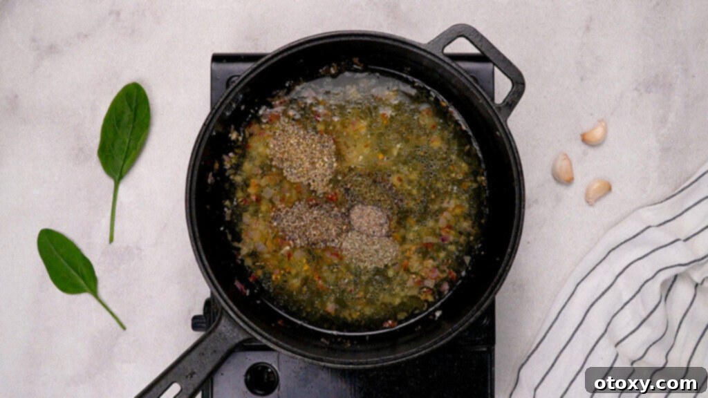 Shallots and garlic sautéing in butter, followed by chicken broth and herbs for sauce base
