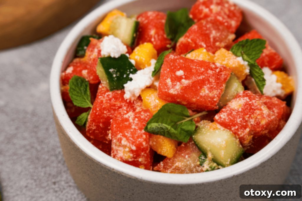 Watermelon Feta Summer Bliss 11 Overhead shot of a vibrant watermelon feta salad in a bowl, showcasing the fresh ingredients.