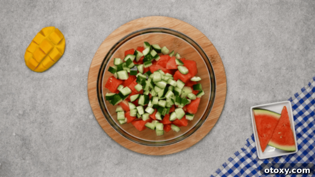 Watermelon Feta Summer Bliss 6 Arranging cubed watermelon and diced cucumber on a platter.