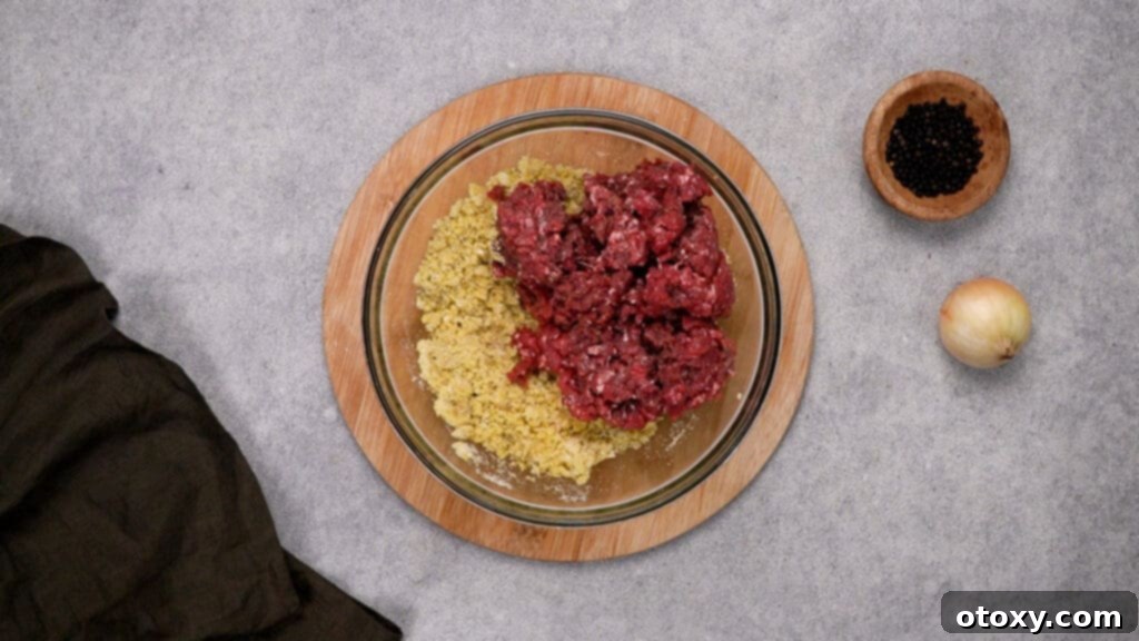 Crispy, Juicy Air Fryer Meatballs 6 Ground beef added to the seasoning and breadcrumb mixture in a bowl