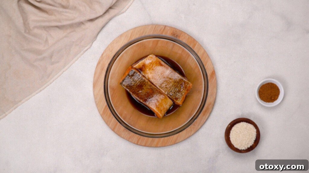 Salmon fillets marinating in miso glaze in a bowl