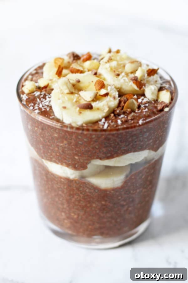 Guilt-Free Chocolate Chia Treat 2 Decadent Chocolate Chia Pudding topped with fresh banana slices, crunchy chopped almonds, and delicate shredded coconut, ready for a healthy breakfast or dessert.