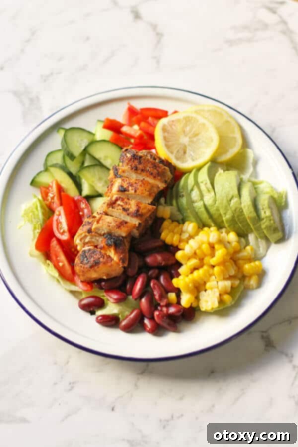 Fiesta Chicken Salad 4 A vibrant Mexican Chicken Salad presented in a bowl, with clear visibility of all fresh ingredients and sliced chicken, ready for a healthy meal.