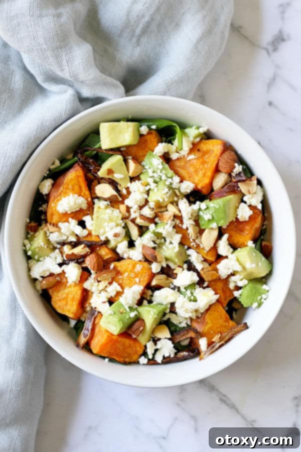 Close-up of a vibrant Roasted Sweet Potato, Avocado, and Feta Salad with a honey lemon vinaigrette, served in a white bowl, ready to be enjoyed.
