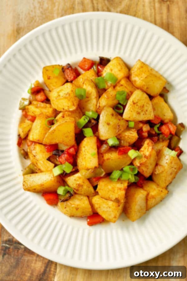 crispy breakfast potatoes on a white plate