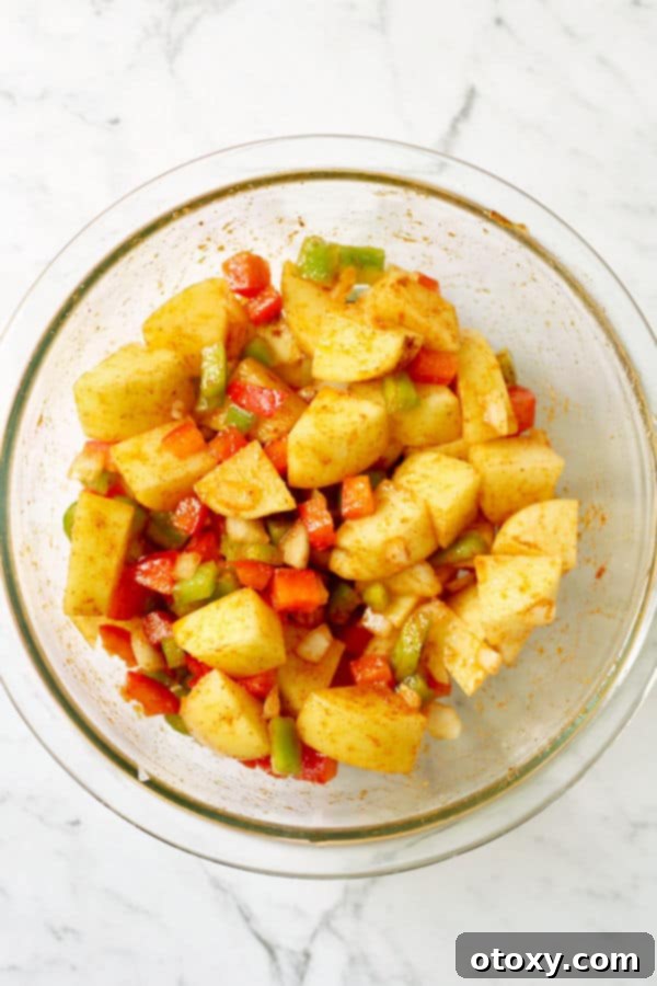 crispy breakfast potatoes ingredients in a glass bowl