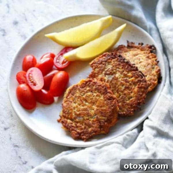 Healthy Zucchini Fritters: Gluten-Free, Paleo and Whole30 2 Freshly cooked gluten-free carrot and zucchini fritters stacked on a white plate