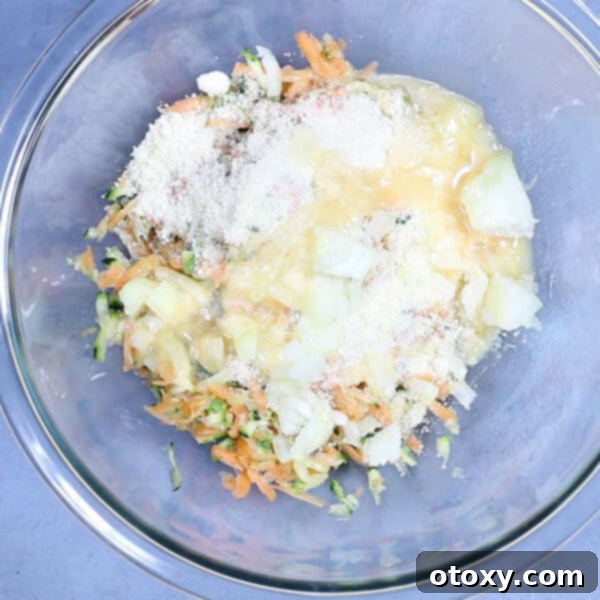 Healthy Zucchini Fritters: Gluten-Free, Paleo and Whole30 6 Bowl of shredded carrot, zucchini, onion, and spices, before mixing