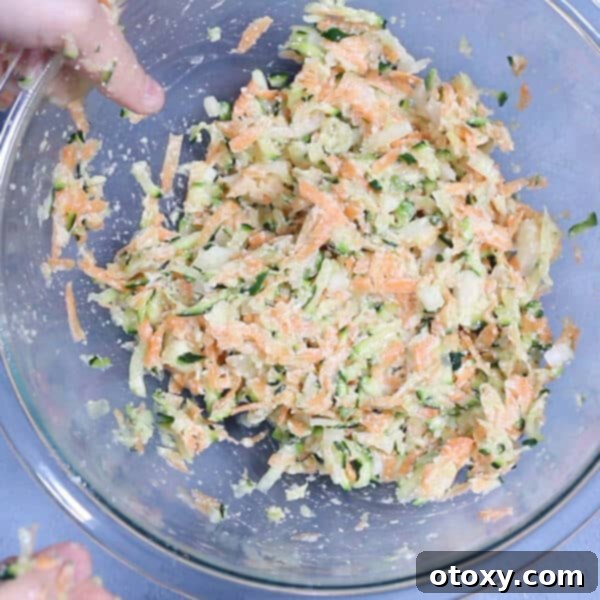 Healthy Zucchini Fritters: Gluten-Free, Paleo and Whole30 7 Well-mixed carrot and zucchini fritter batter in a glass bowl